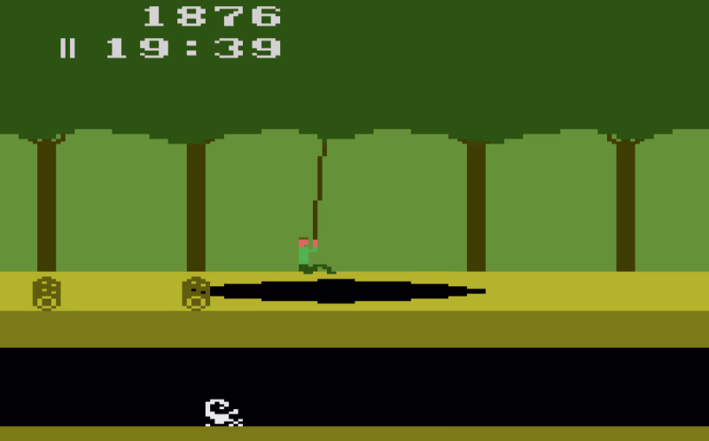 Screenshot of the main character swinging from a vine over a pit.